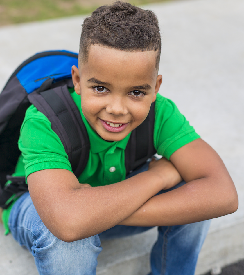 Child sitting down smiling